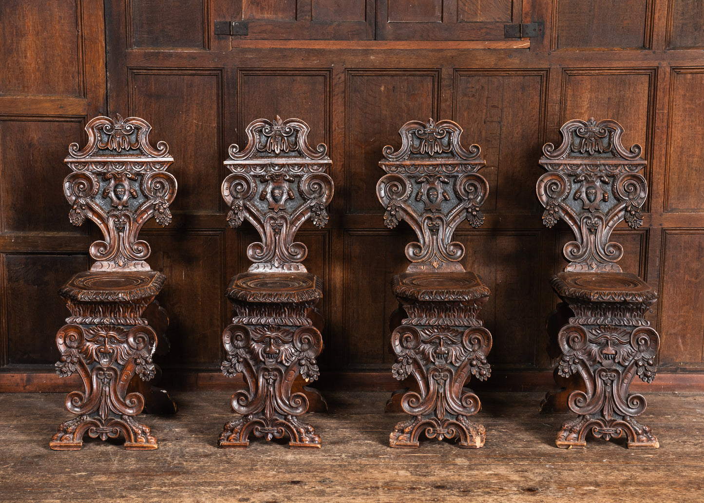 Four Carved Walnut Sgabello Hall Chairs