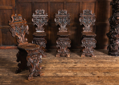 Four Carved Walnut Sgabello Hall Chairs