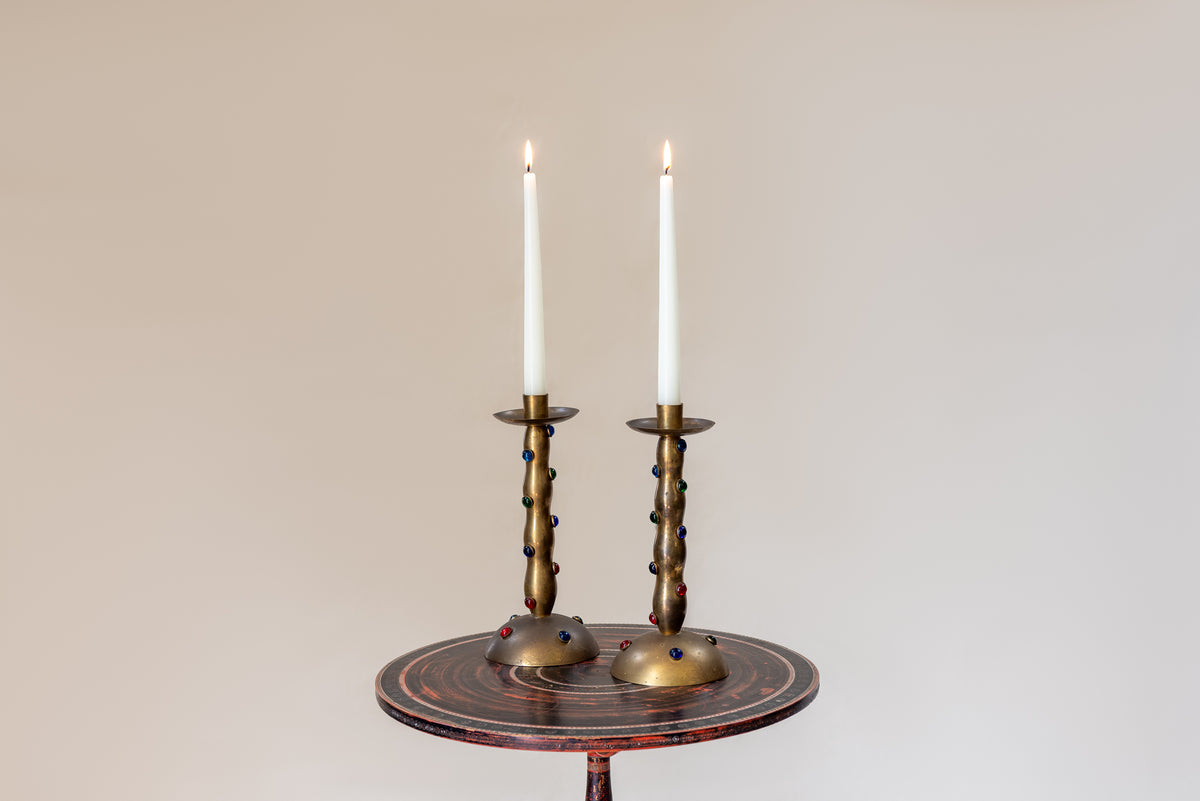 A Pair of Cabochon Mounted Brass Candlesticks