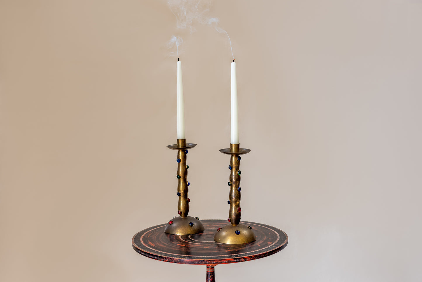 A Pair of Cabochon Mounted Brass Candlesticks