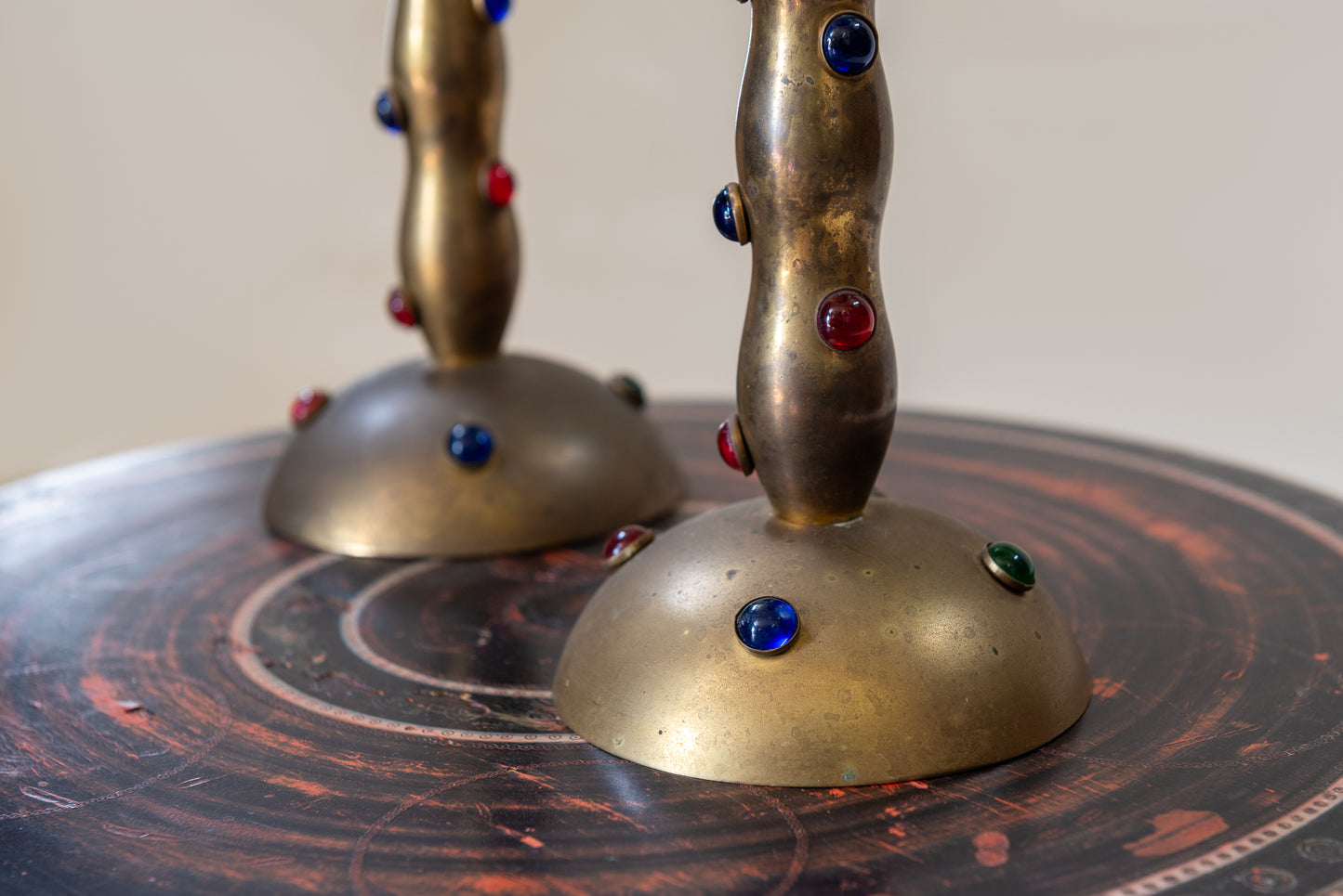 A Pair of Cabochon Mounted Brass Candlesticks